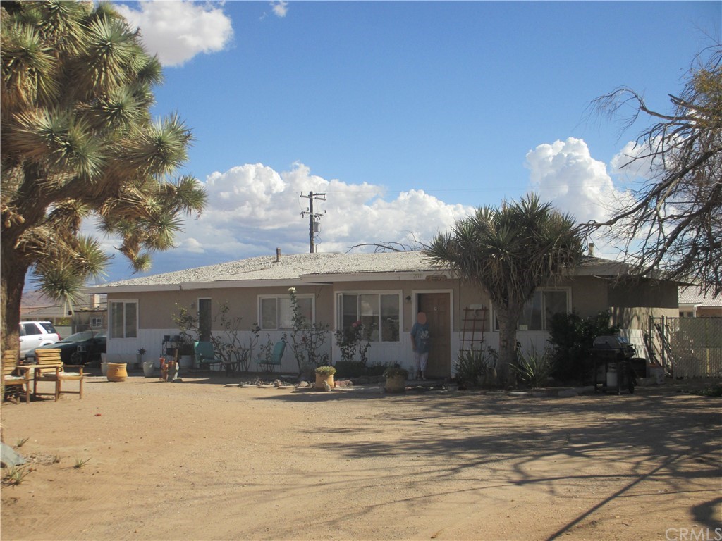 21111 S Road Apple Valley, CA 92307 - Photo 1 of 1 a front view of a house with a yard covered with snow and trees