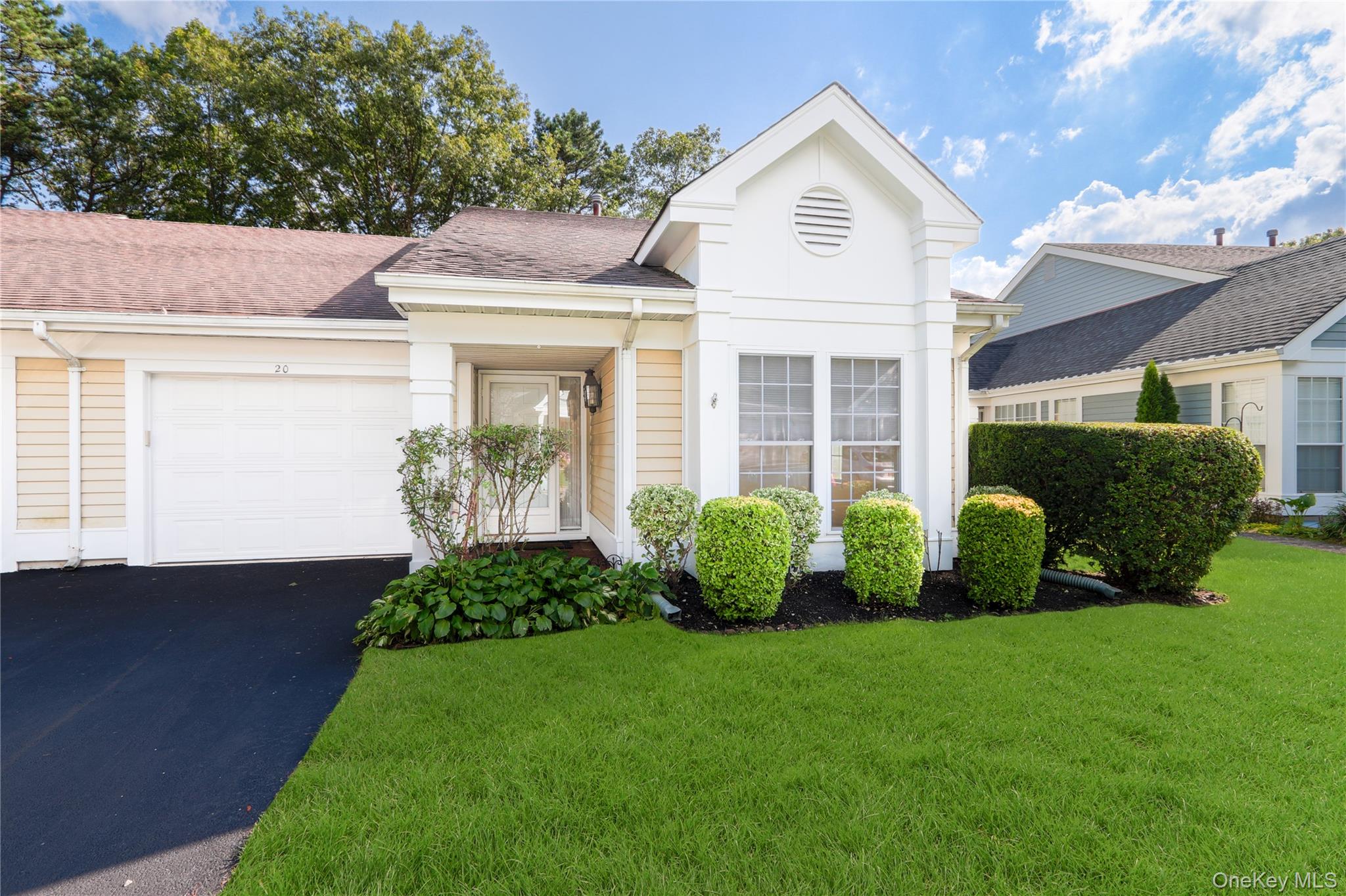 20 Amagansett Court Ridge, NY 11961 - Photo 1 of 1 a front view of a house with garden