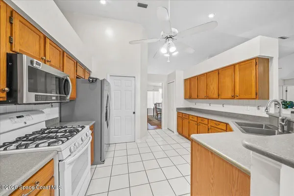 a kitchen with stainless steel appliances a sink stove and refrigerator