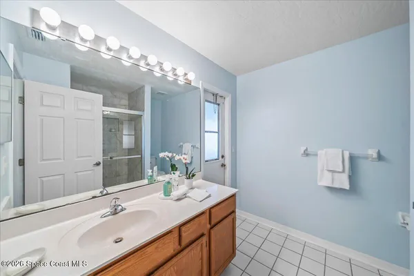 a bathroom with a sink vanity and a mirror