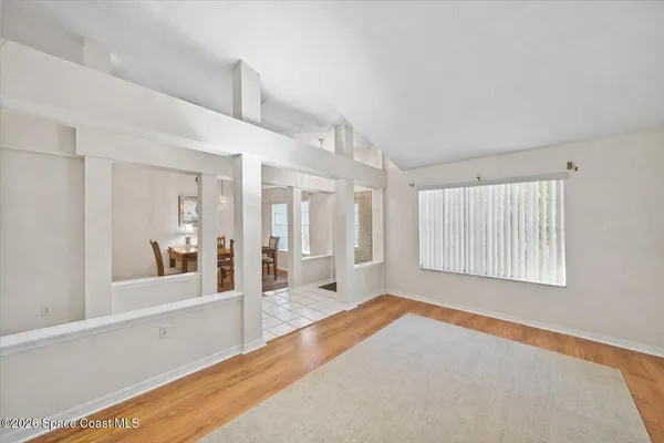 a spacious bedroom with a bed and a large window