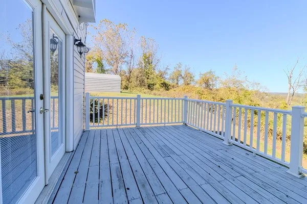 a view of a balcony with wooden floor