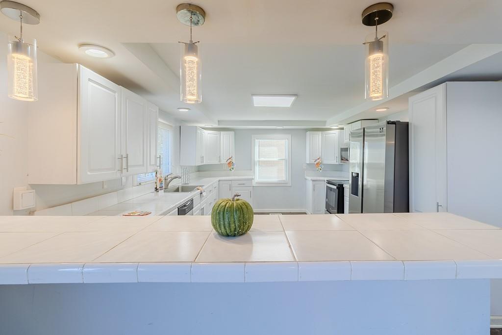 7583 Tyler Road Verona, PA 15147 - Photo 13 of 50 a view of a kitchen center island and stainless steel appliances