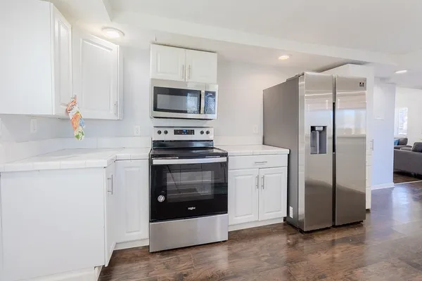 a kitchen with stainless steel appliances a refrigerator stove and microwave