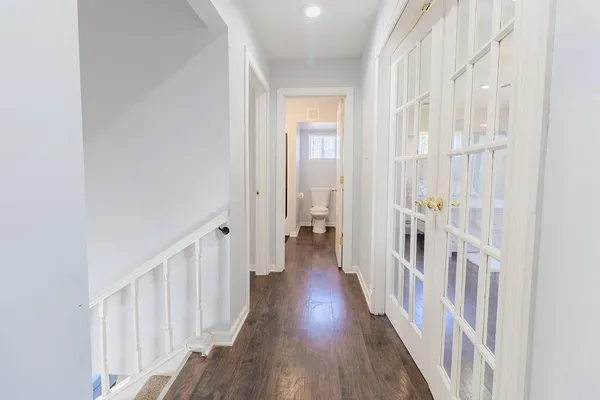 a view of a hallway with a wooden floor