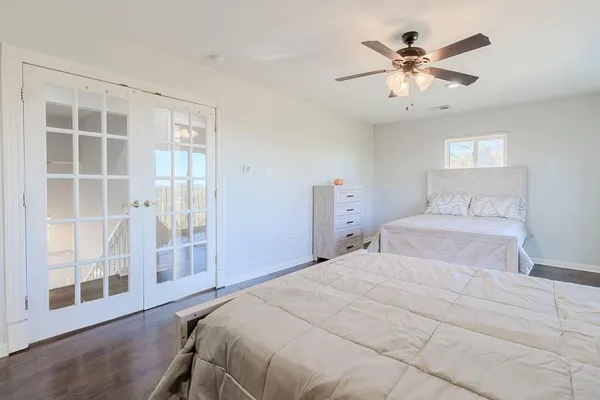 a bedroom with a large bed and a window