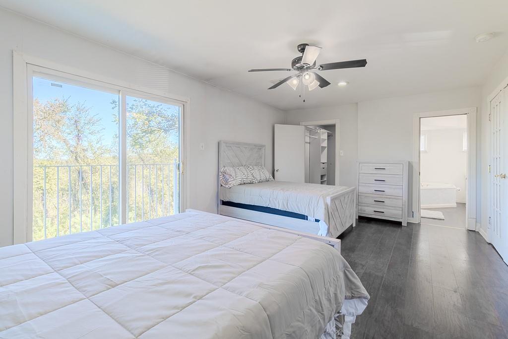 7583 Tyler Road Verona, PA 15147 - Photo 23 of 50 a spacious bedroom with a large bed and a chandelier