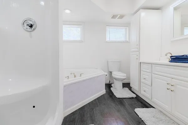 a bathroom with a bathtub and toilet