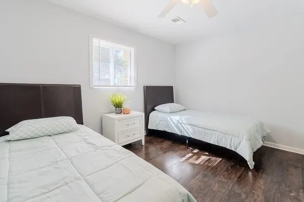 a bedroom with a bed and window