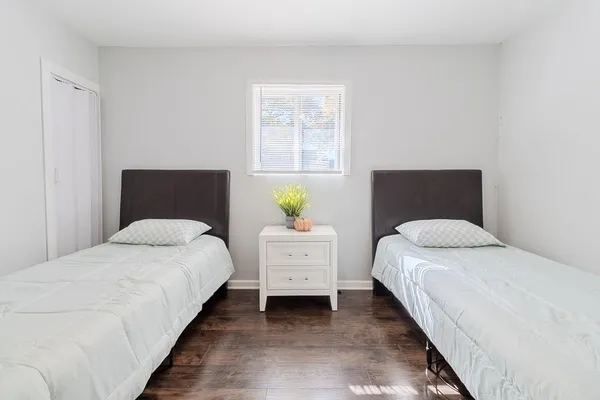 a bedroom with a bed and window