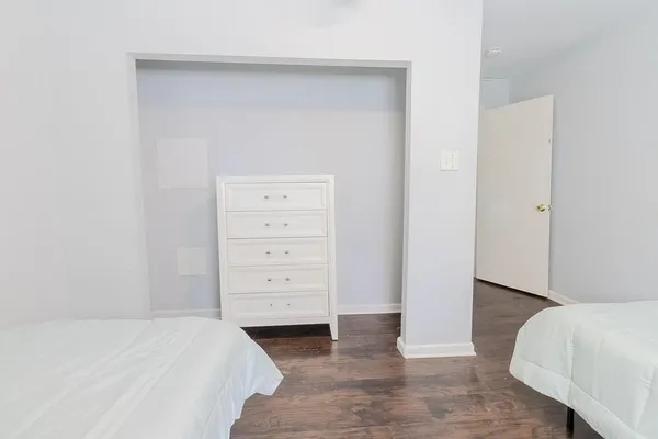 a bedroom with a bed and a dresser