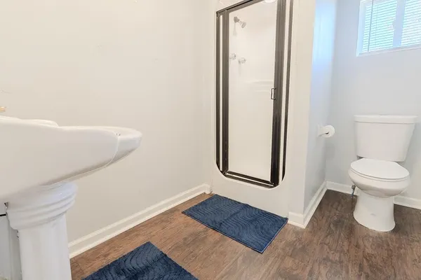 a bathroom with a toilet and a shower