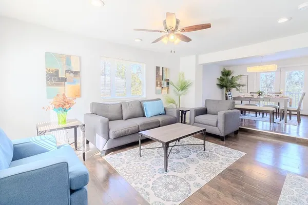 a living room with furniture and wooden floor
