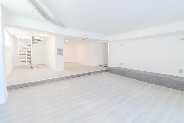 an empty room with a empty space and windows