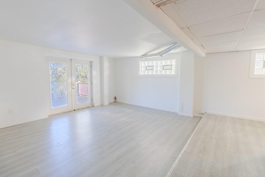 7583 Tyler Road Verona, PA 15147 - Photo 38 of 50 an empty room with wooden floor and windows