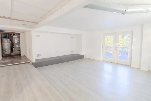 wooden floor in an empty room with a window