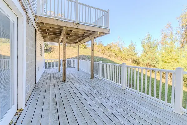 a view of a wooden deck with a yard
