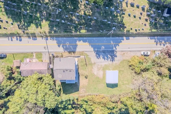 an aerial view of a house with a yard