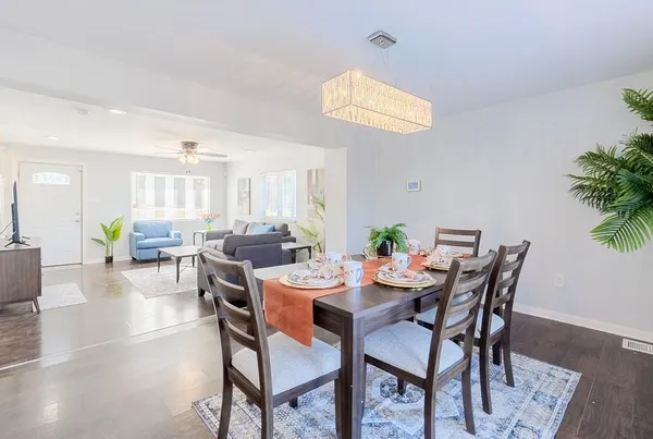 a view of a dining room with furniture and wooden floor