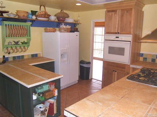 1226 Lorimer Road Raleigh, NC 27606 - Photo 6 of 12 Updated Kitchen with granite & tile countertops and tile floor!