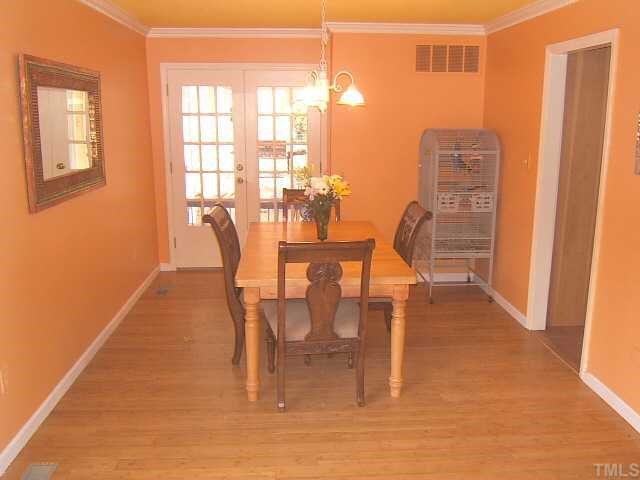 1226 Lorimer Road Raleigh, NC 27606 - Photo 8 of 12 Dining Room with bamboo floors and french doors to deck/covered porch!