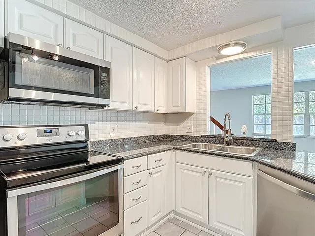 a view of a hallway with stairs and a couch