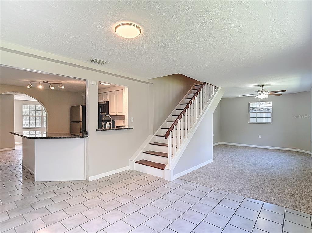 7827 Butler Avenue Hudson, FL 34667 - Photo 18 of 82 a view of a hallway with stairs and a couch