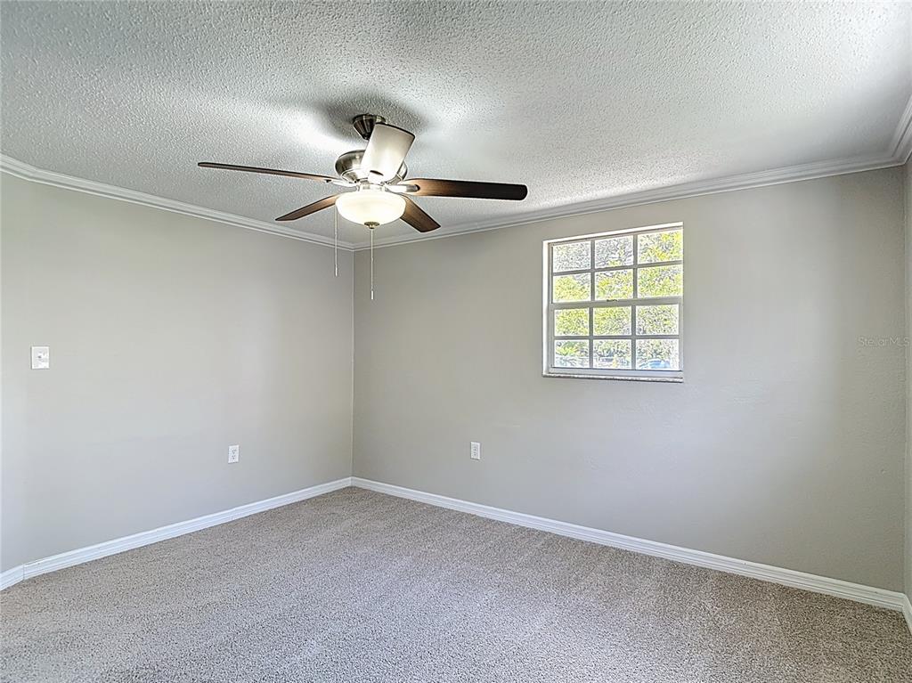 7827 Butler Avenue Hudson, FL 34667 - Photo 26 of 82 an empty room with windows and fan