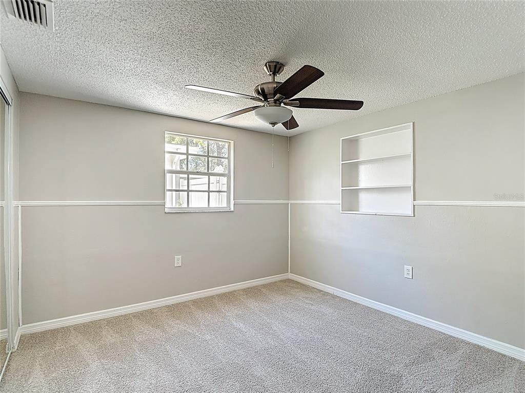 7827 Butler Avenue Hudson, FL 34667 - Photo 27 of 82 an empty room with windows and fan
