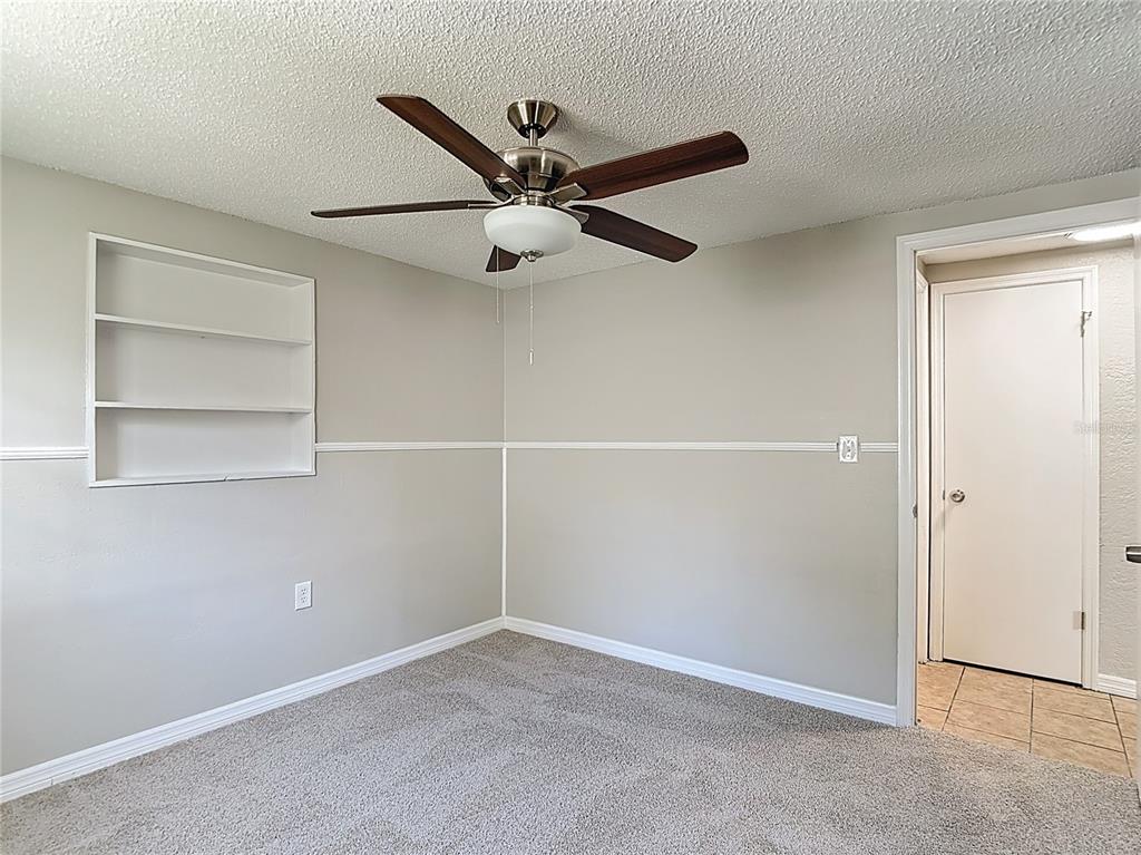 7827 Butler Avenue Hudson, FL 34667 - Photo 30 of 82 an empty room with closet and a ceiling fan