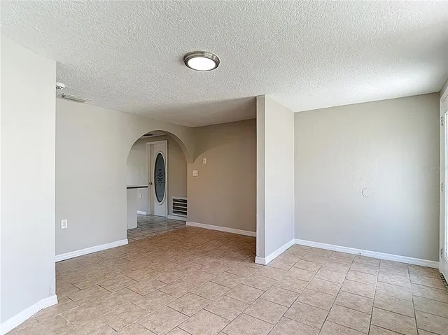 a kitchen with stainless steel appliances granite countertop a stove a sink dishwasher a refrigerator and a microwave