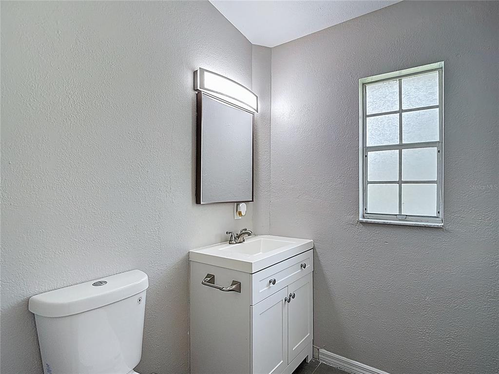 7827 Butler Avenue Hudson, FL 34667 - Photo 52 of 82 a bathroom with a toilet sink and mirror