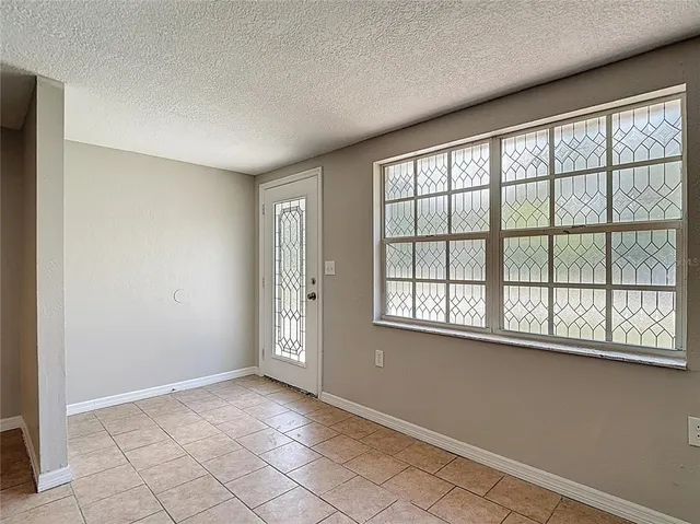 a white kitchen with granite countertop stainless steel appliances and white cabinets