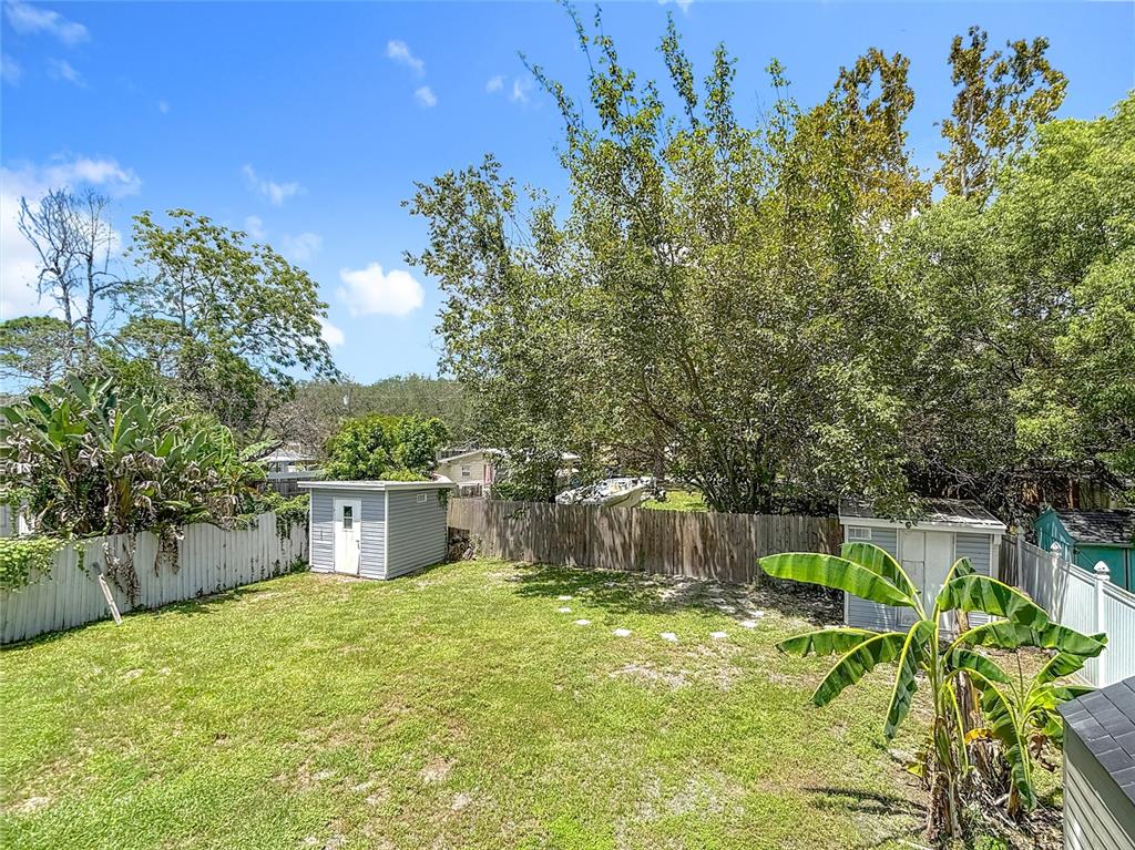 7827 Butler Avenue Hudson, FL 34667 - Photo 66 of 82 a backyard of a house with table and chairs