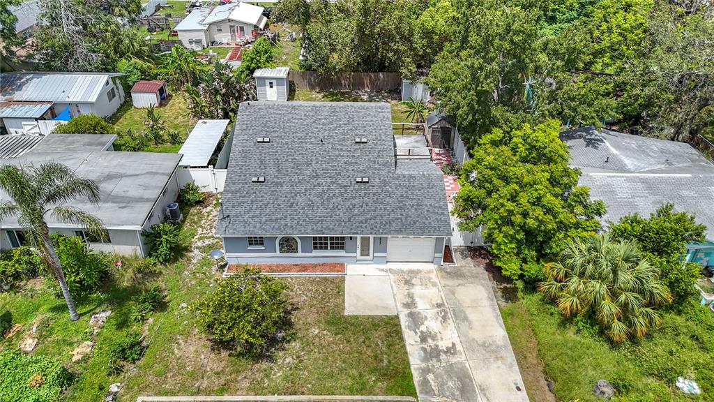 7827 Butler Avenue Hudson, FL 34667 - Photo 69 of 82 an aerial view of a house with a yard and large trees