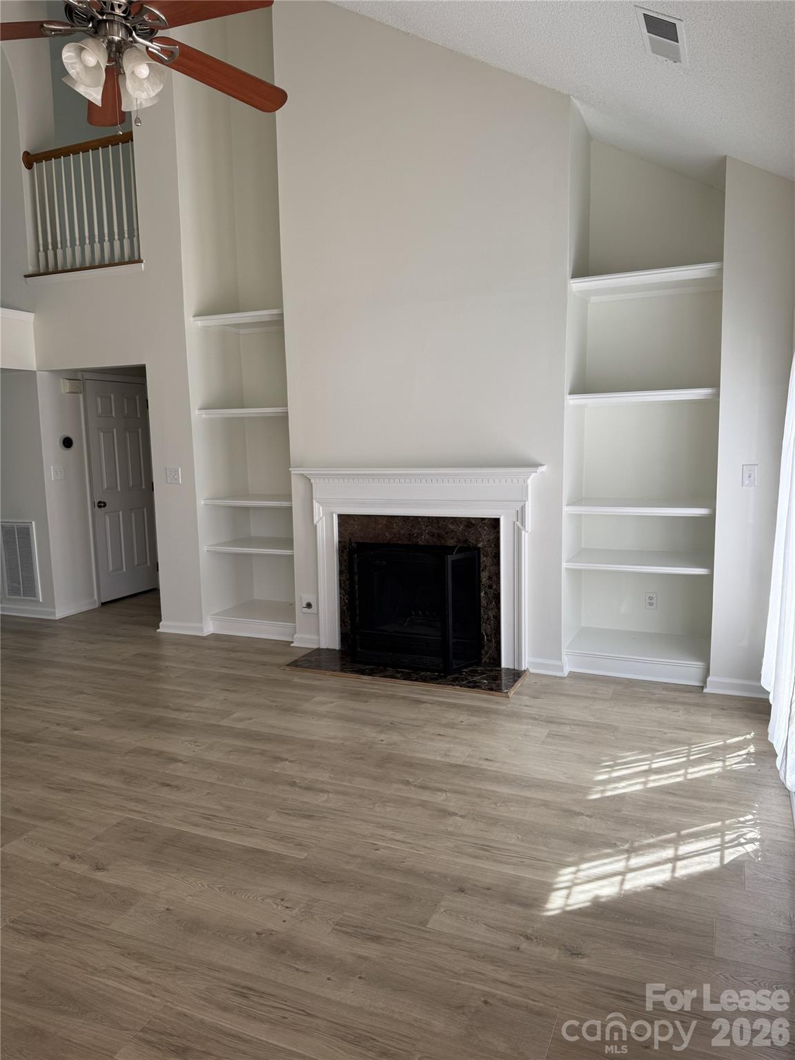 11408 Coreopsis Road Charlotte, NC 28213 - Photo 12 of 38 a view of empty room with wooden floor and fireplace