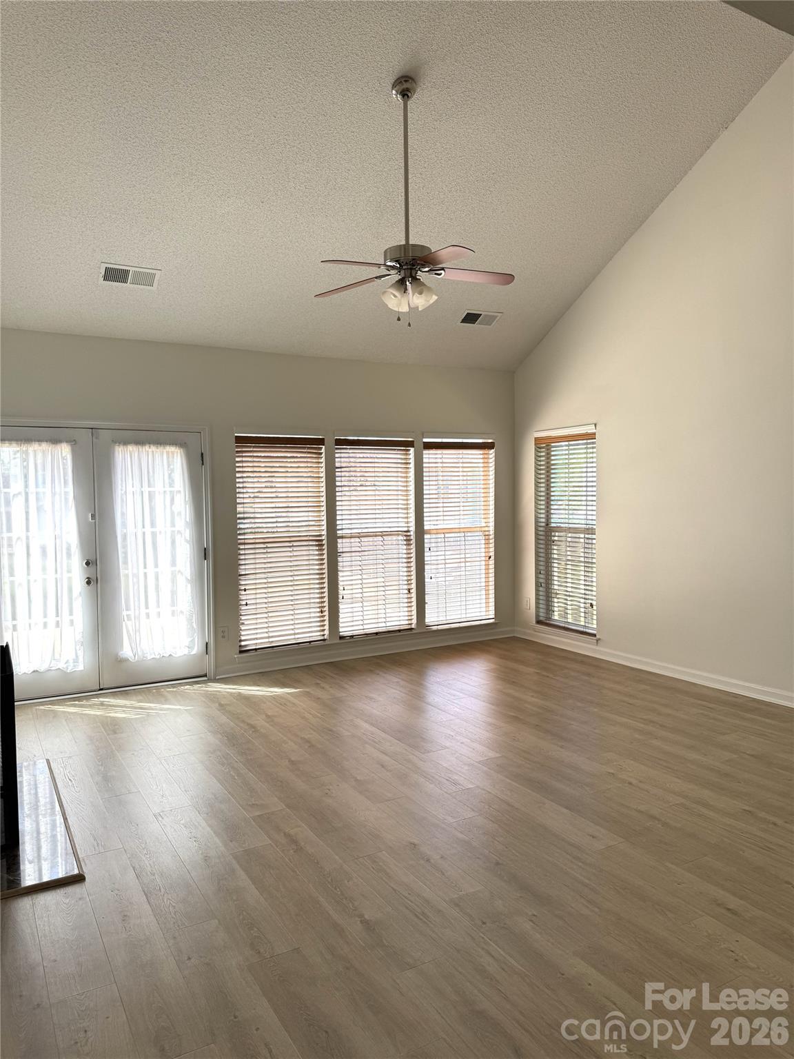 11408 Coreopsis Road Charlotte, NC 28213 - Photo 14 of 38 a view of an empty room with a window and wooden floor