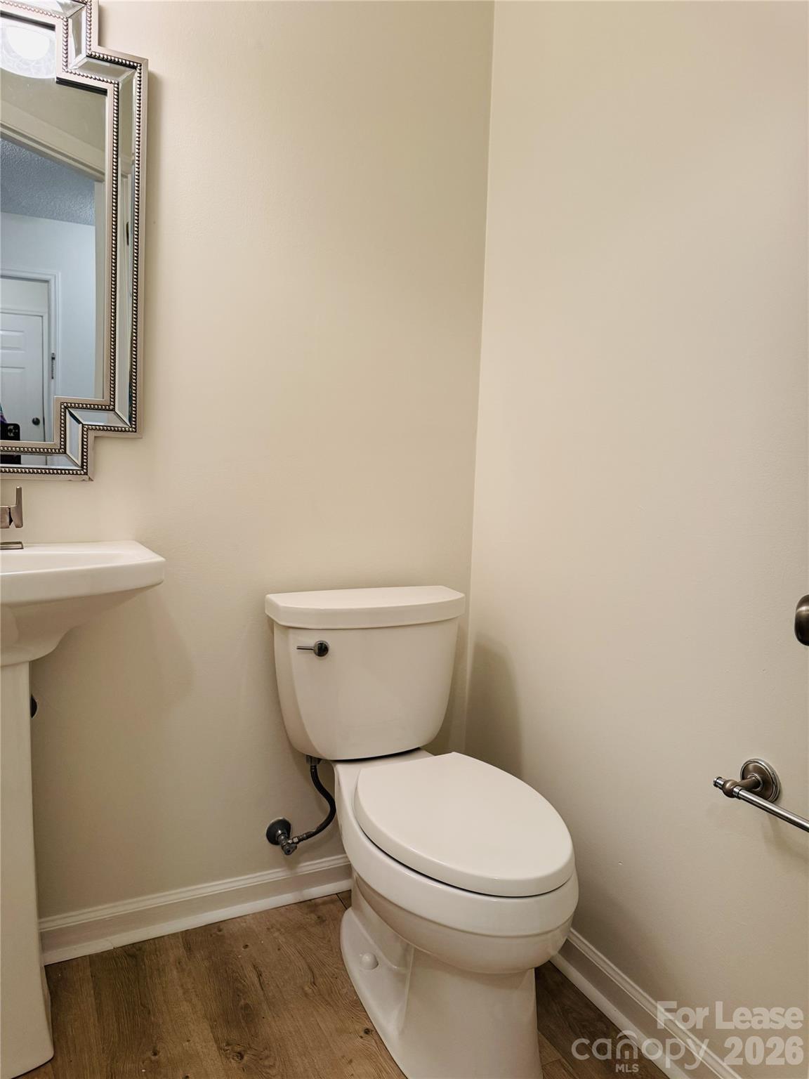11408 Coreopsis Road Charlotte, NC 28213 - Photo 17 of 38 a bathroom with a toilet a sink and mirror