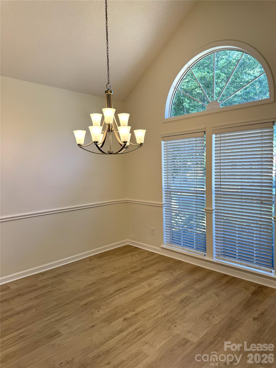 11408 Coreopsis Road Charlotte, NC 28213 - Photo 4 of 38 an empty room with wooden floor fan and window