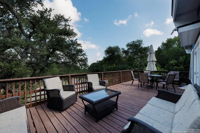 a roof deck with couches and wooden floor