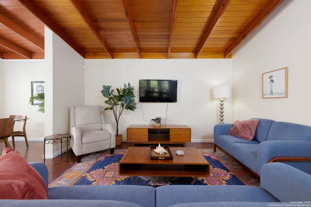 a living room with furniture a couch and a flat screen tv
