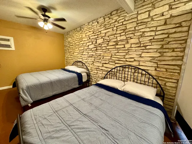 a bedroom with two beds and a chandelier