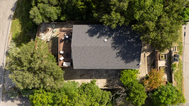 an aerial view of a house with a yard