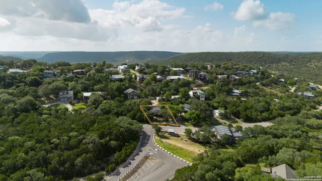 an aerial view of residential house with outdoor space and trees
