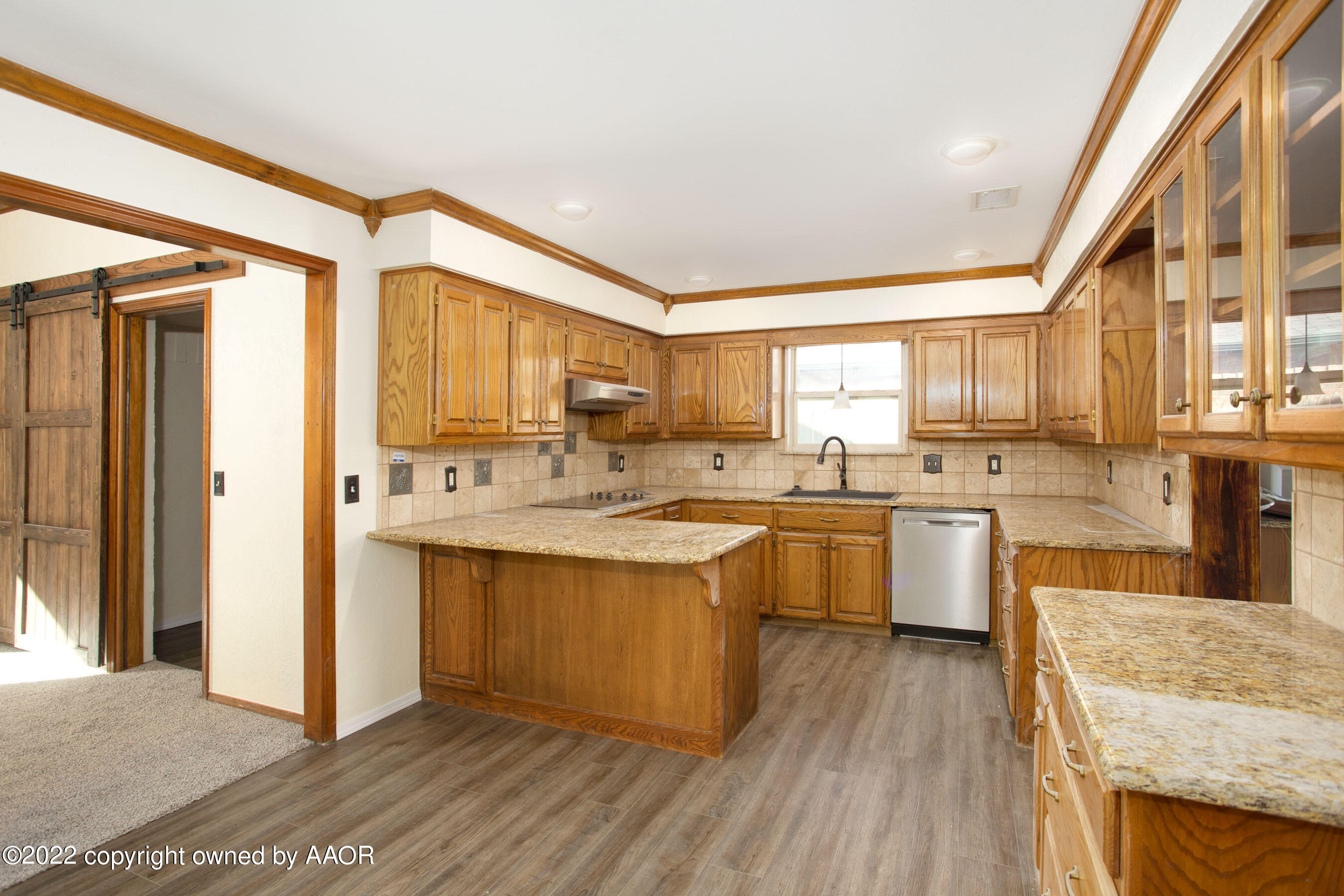 5000 Carmel Avenue Amarillo, TX 79110 - Photo 8 of 35 a large kitchen with a lot of counter space and wooden floor