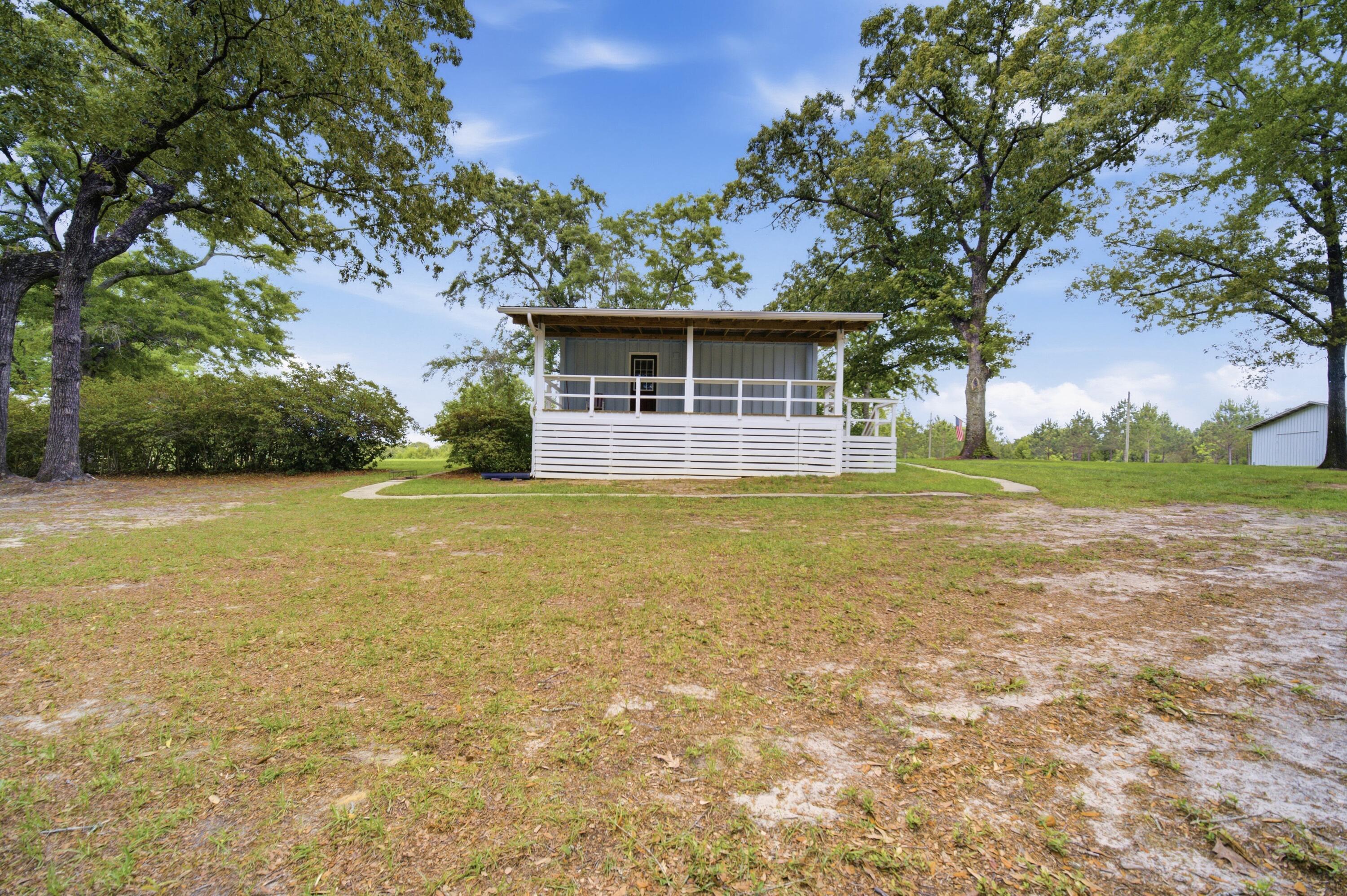 261 Wilkerson Road DeFuniak Springs, FL 32433 - Photo 63 of 76 a view of a house with yard and tree s