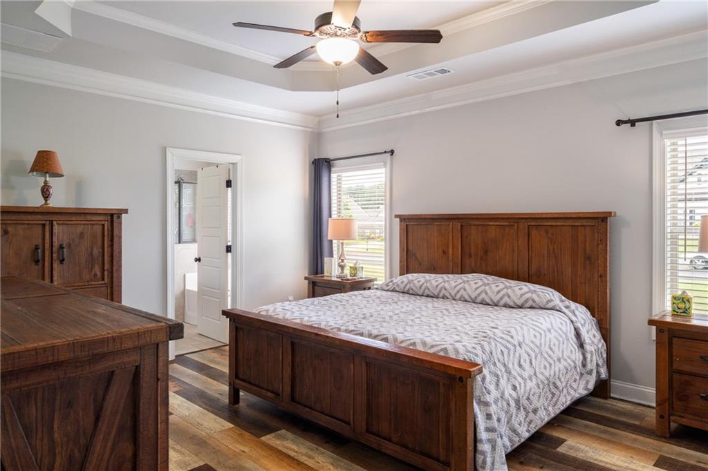 712 Fleeting Way Monroe, GA 30655 - Photo 15 of 29 a bedroom with a bed and a dresser