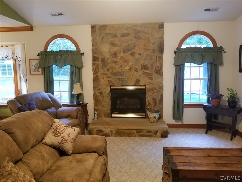 2057 Mill Road Henrico, VA 23231 - Photo 28 of 44 a living room with furniture a fireplace and a floor to ceiling window