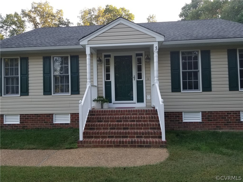 2057 Mill Road Henrico, VA 23231 - Photo 3 of 44 a front view of a house with a garden