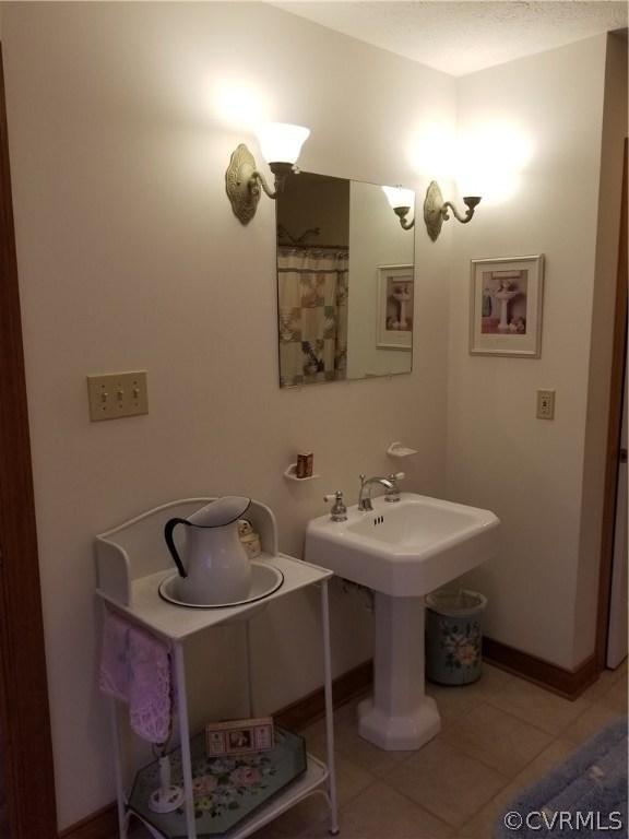 2057 Mill Road Henrico, VA 23231 - Photo 43 of 44 a bathroom with a sink and a mirror
